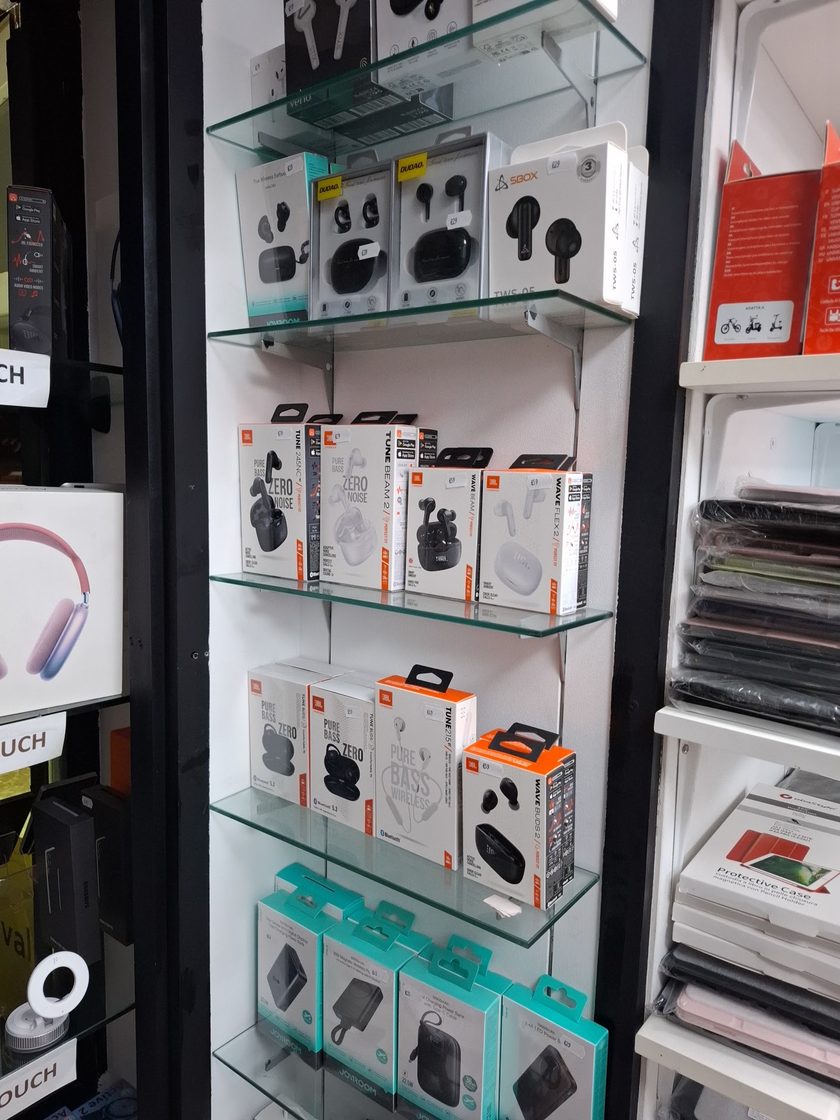 The accessory corner, with the earbuds cabinet on the left and stacked protective cases and tablet covers on the shelving to the right